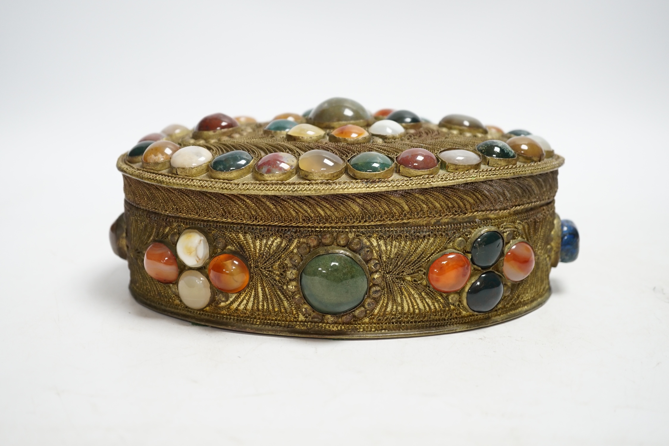 A brass filigree work and agate cabochon mounted oval box, 19cm wide